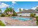 Community swimming pool with a brick paved deck at 7952 Grand Pines Blvd, Lakeland, FL 33810