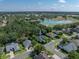 An aerial perspective showcases the house within a beautiful neighborhood, complete with a golf course and pond at 800 Osprey Landing Dr, Lakeland, FL 33813