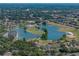 Aerial view of a residential community with a scenic lake and golf course at 800 Osprey Landing Dr, Lakeland, FL 33813
