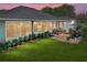 Enjoy the serene backyard with a brick patio, lush greenery, and ample seating at 800 Osprey Landing Dr, Lakeland, FL 33813