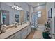 Bathroom with a single vanity, large mirror, and tub-shower combo at 800 Osprey Landing Dr, Lakeland, FL 33813