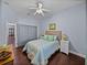 Cozy bedroom with a ceiling fan, wood floors and neutral-colored walls at 800 Osprey Landing Dr, Lakeland, FL 33813