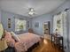 Bedroom with hardwood floors, ceiling fan, two windows and an attached bathroom at 800 Osprey Landing Dr, Lakeland, FL 33813