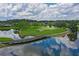 Picturesque golf course view featuring a scenic bridge and tranquil lake at 800 Osprey Landing Dr, Lakeland, FL 33813