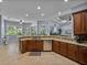 Open kitchen with granite countertops, stainless steel appliances, and a breakfast bar overlooking the living room at 800 Osprey Landing Dr, Lakeland, FL 33813
