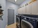 Laundry room with washer and dryer, storage cabinets, and neutral-colored walls at 800 Osprey Landing Dr, Lakeland, FL 33813