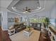 Bright living room with hardwood floors, neutral rug, and view of the kitchen and backyard pool at 800 Osprey Landing Dr, Lakeland, FL 33813