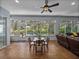 Well-lit sun room with sliding glass doors to the back and a view of the pool and manicured yard at 800 Osprey Landing Dr, Lakeland, FL 33813