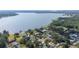 Breathtaking aerial view of a lakefront community, surrounded by lush greenery and serene waters at 818 Fairlane Dr, Lakeland, FL 33809