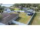 An aerial view of the fenced backyard, shed, RV awning, and nearby lake at 818 Fairlane Dr, Lakeland, FL 33809