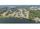 Stunning aerial perspective of a lakefront neighborhood with lush trees, docks, and shimmering waters at 818 Fairlane Dr, Lakeland, FL 33809