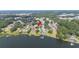Beautiful lake view aerial of a lake community with docks and many trees pointing to property location at 818 Fairlane Dr, Lakeland, FL 33809
