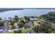 Aerial view of lakeside homes with lush lawns and mature trees, offering serene waterfront living at 818 Fairlane Dr, Lakeland, FL 33809