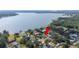 Aerial view of a waterfront community with tree coverage pointing to home location at 818 Fairlane Dr, Lakeland, FL 33809