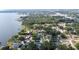 Scenic aerial shot of lakefront homes surrounded by lush trees and sparkling waters at 818 Fairlane Dr, Lakeland, FL 33809