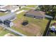 Spacious fenced backyard featuring a trampoline, storage shed, and covered parking area at 818 Fairlane Dr, Lakeland, FL 33809