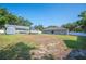 An overview of the home's fenced backyard with a trampoline, shed, and RV awning at 818 Fairlane Dr, Lakeland, FL 33809
