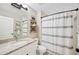 Well-lit bathroom with granite countertops, a decorative shower curtain, and tasteful decor at 818 Fairlane Dr, Lakeland, FL 33809