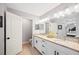 Bright bathroom with a double vanity, granite countertops, a toilet room, and a walk-in shower at 818 Fairlane Dr, Lakeland, FL 33809
