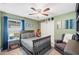 Comfortable bedroom featuring a gray bed, ample natural light, and cozy decor at 818 Fairlane Dr, Lakeland, FL 33809