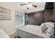 Cozy bedroom featuring a built-in closet, a window with blinds, and a ceiling fan at 818 Fairlane Dr, Lakeland, FL 33809