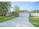 Charming home featuring an attached two-car garage, and a well-maintained front yard at 818 Fairlane Dr, Lakeland, FL 33809