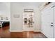 Open foyer with views into the living room and kitchen, and hardwood flooring at 818 Fairlane Dr, Lakeland, FL 33809