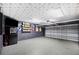 Spacious garage with epoxy floors, ample lighting, and unique ceiling at 818 Fairlane Dr, Lakeland, FL 33809