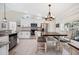 Bright kitchen featuring white cabinets, granite countertops, and an adjacent dining area at 818 Fairlane Dr, Lakeland, FL 33809