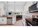 Modern open-concept kitchen featuring stainless steel appliances and granite countertops at 818 Fairlane Dr, Lakeland, FL 33809