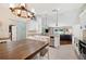 Well-lit kitchen with white cabinets, granite countertops and an adjoining dining area at 818 Fairlane Dr, Lakeland, FL 33809