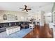 Cozy living room with hardwood floors, a comfortable sectional and views into the kitchen at 818 Fairlane Dr, Lakeland, FL 33809
