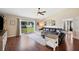 Spacious living room featuring hardwood floors, ceiling fan and sliding glass doors to the backyard at 818 Fairlane Dr, Lakeland, FL 33809
