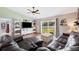 Bright living room featuring a sliding glass door with backyard views and stylish decor at 818 Fairlane Dr, Lakeland, FL 33809