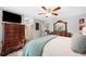 Serene main bedroom featuring a ceiling fan, a dresser, and an ensuite bathroom at 818 Fairlane Dr, Lakeland, FL 33809