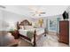 Elegant main bedroom with a ceiling fan, a window with curtains, and stylish furniture at 818 Fairlane Dr, Lakeland, FL 33809