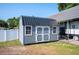 A shed with white trim is located in the home's backyard at 818 Fairlane Dr, Lakeland, FL 33809