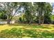 Spacious backyard with mature trees offering ample shade and a serene setting at 909 Lake Deeson Pt, Lakeland, FL 33805