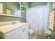 Bathroom featuring a vanity with a single sink, a framed mirror, shelving, and a shower/tub combination at 909 Lake Deeson Pt, Lakeland, FL 33805