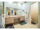 Bathroom features a large mirror, double sinks, tiled floors, and separate toilet area at 909 Lake Deeson Pt, Lakeland, FL 33805