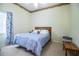 Cozy bedroom featuring a comfortable queen size bed and a window for natural light at 909 Lake Deeson Pt, Lakeland, FL 33805