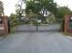 Ornate wrought iron gate with brick columns marks the entry to the Lake Deeson community at 909 Lake Deeson Pt, Lakeland, FL 33805