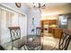 Dining area featuring a glass table and chairs, tile flooring, and views of the kitchen at 909 Lake Deeson Pt, Lakeland, FL 33805