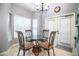 Dining Area featuring tile floors, a glass table with four chairs and a chandelier at 909 Lake Deeson Pt, Lakeland, FL 33805