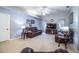 Spacious living room with comfortable leather furniture, neutral carpet, and plenty of natural light at 909 Lake Deeson Pt, Lakeland, FL 33805
