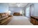 Bright living room featuring neutral carpet, large window, and comfortable seating at 909 Lake Deeson Pt, Lakeland, FL 33805