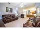 Spacious living room with leather furniture, neutral carpet, ceiling fan, and an open floor plan at 909 Lake Deeson Pt, Lakeland, FL 33805