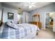 Spacious main bedroom with a four poster bed, ensuite bathroom, and walk-in closet at 909 Lake Deeson Pt, Lakeland, FL 33805