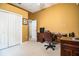 Bright home office featuring a desk, chair, closet, and a window providing natural light at 909 Lake Deeson Pt, Lakeland, FL 33805