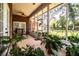 Comfortable screened patio surrounded by greenery and offering a peaceful outdoor space at 909 Lake Deeson Pt, Lakeland, FL 33805
